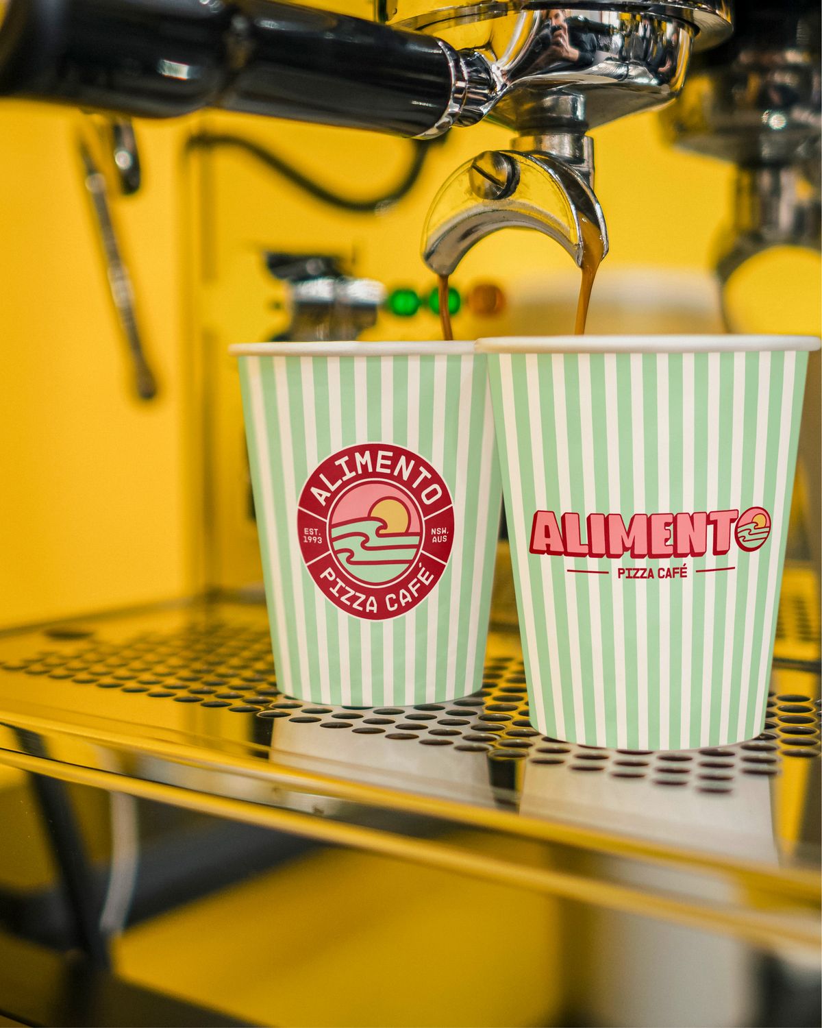 Branded coffee cups on the espresso machine